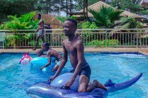 Family swimming in the pool at CrownCity Park & Resort in Agbara